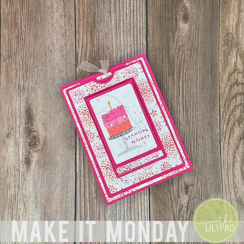 A handmade birthday card featuring a pink and orange cake design with the phrase Counting Wishes on a wooden background.