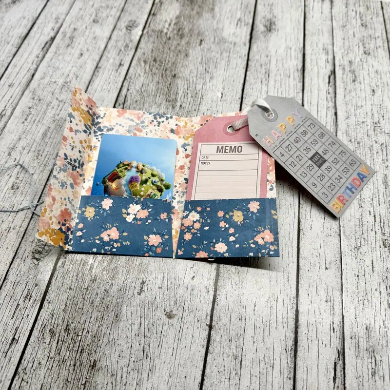 Handmade gift card holder with tags and pockets, made with floral paper.